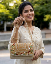 This is a luxury handcrafted clutch by the brand Slingss. It is designed as a statement piece for weddings, parties, and festive occasions.